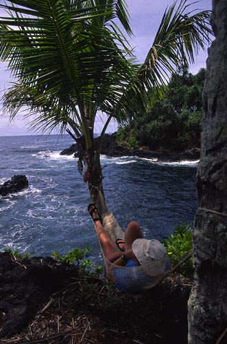 Rusty relaxes in a hammock at "Fish Camp", Ulaino